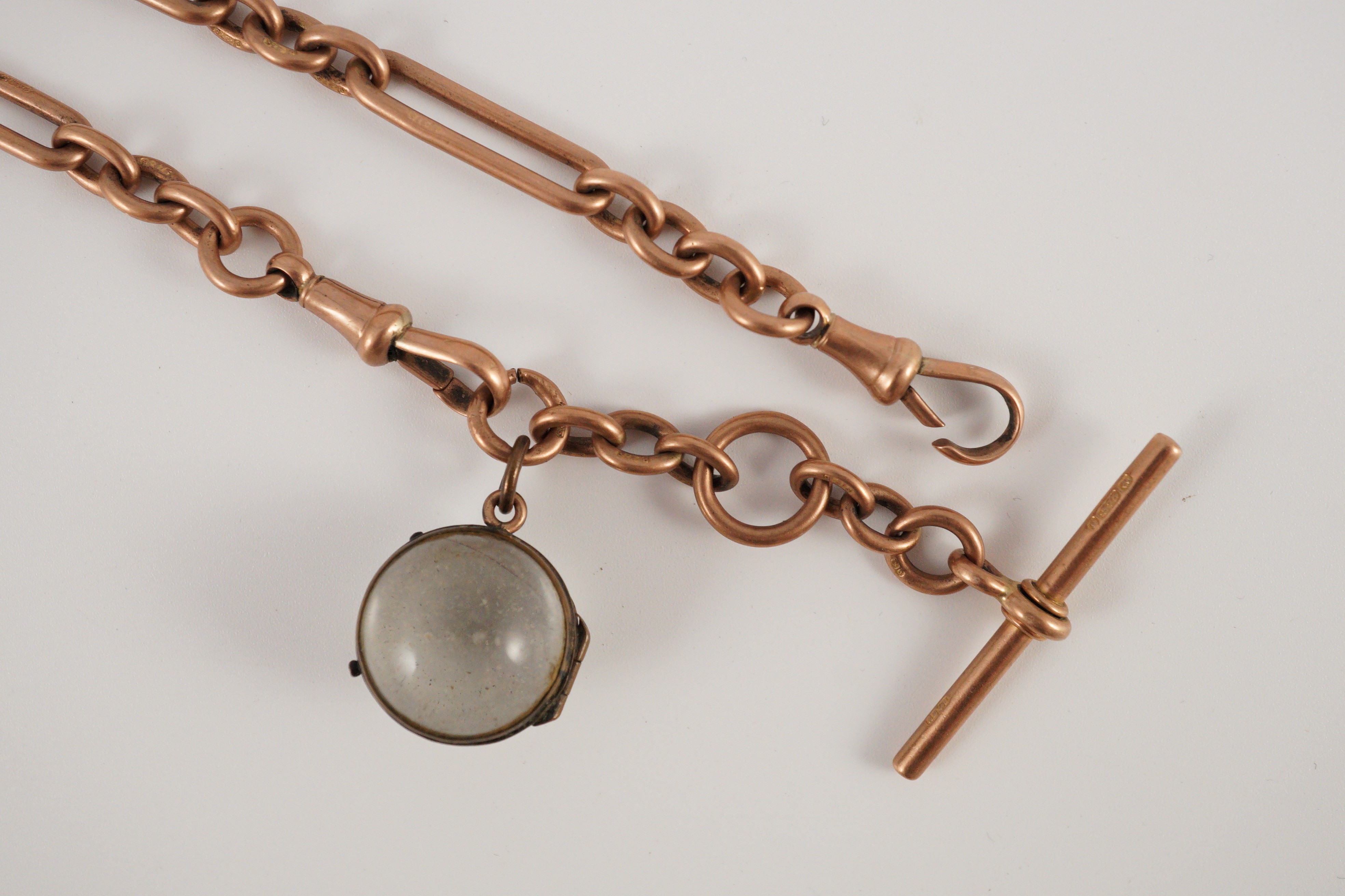 An early 20th century 9ct gold albert with magnified lens fob